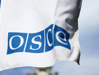 Flag with the OSCE logo in front of the Hofburg, Vienna.